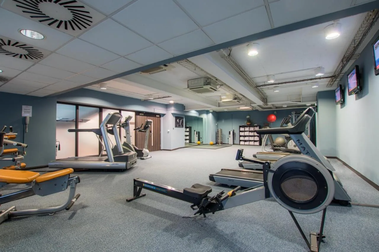 a gym with treadmills and elliptical machines at Crowne Plaza Birmingham City by IHG in Birmingham