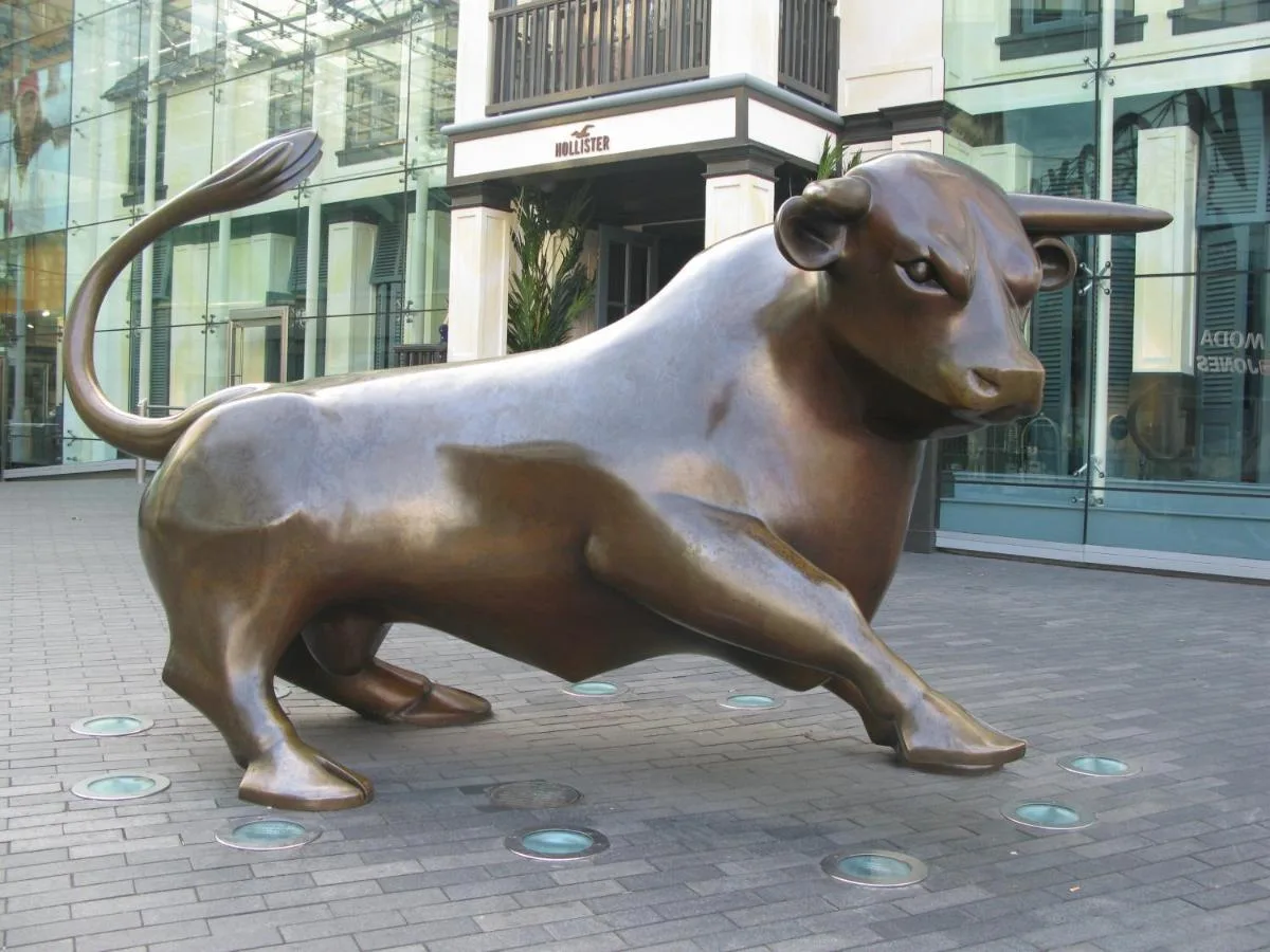 a bronze statue of a bull on a city street at Crowne Plaza Birmingham City by IHG in Birmingham